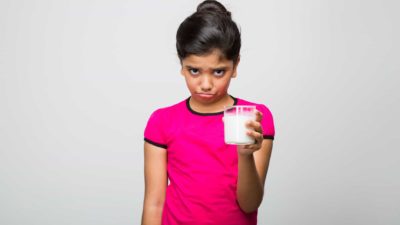 sad milk drinker, infant formula share price drop, fall, decrease