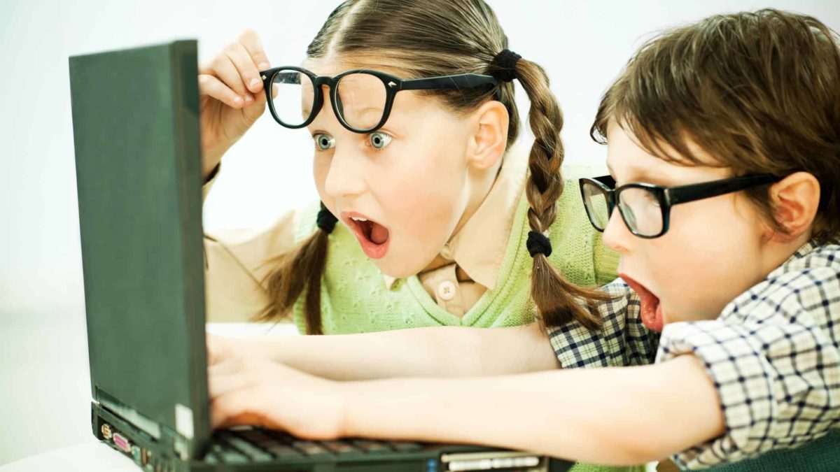 Children excitedly watching an asx share price movement on a computer