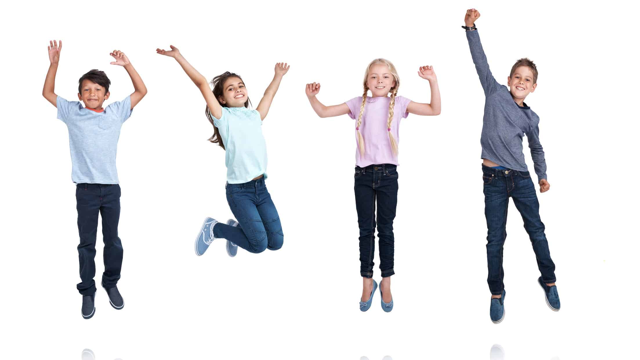 a line up of four children all leap in the air with one or two arms raised and feet off the ground.