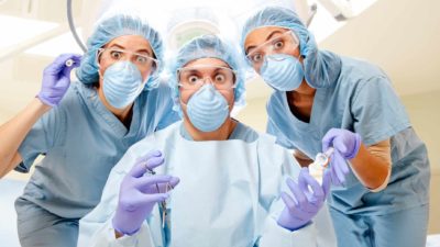 comical medical team wearing masks and scrubs look wide-eyed at the camera, medical shares