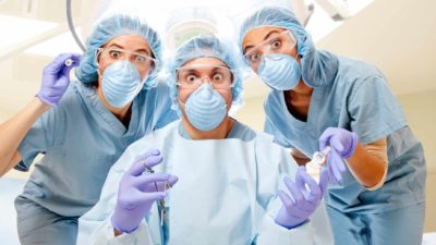 comical medical team wearing masks and scrubs look wide-eyed at the camera, medical shares