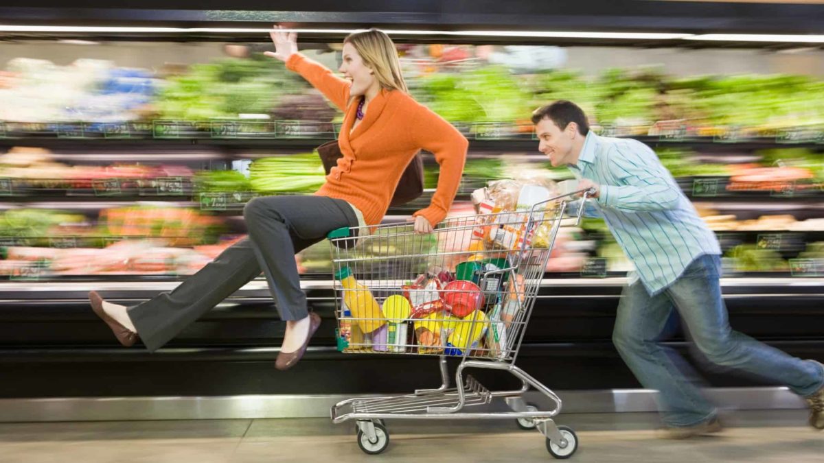 shopping trolley, grocery, retail, supermarkets, a man pushes a woman on a supermarket trolley