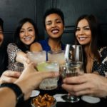 Group of friends toasting with drinks.
