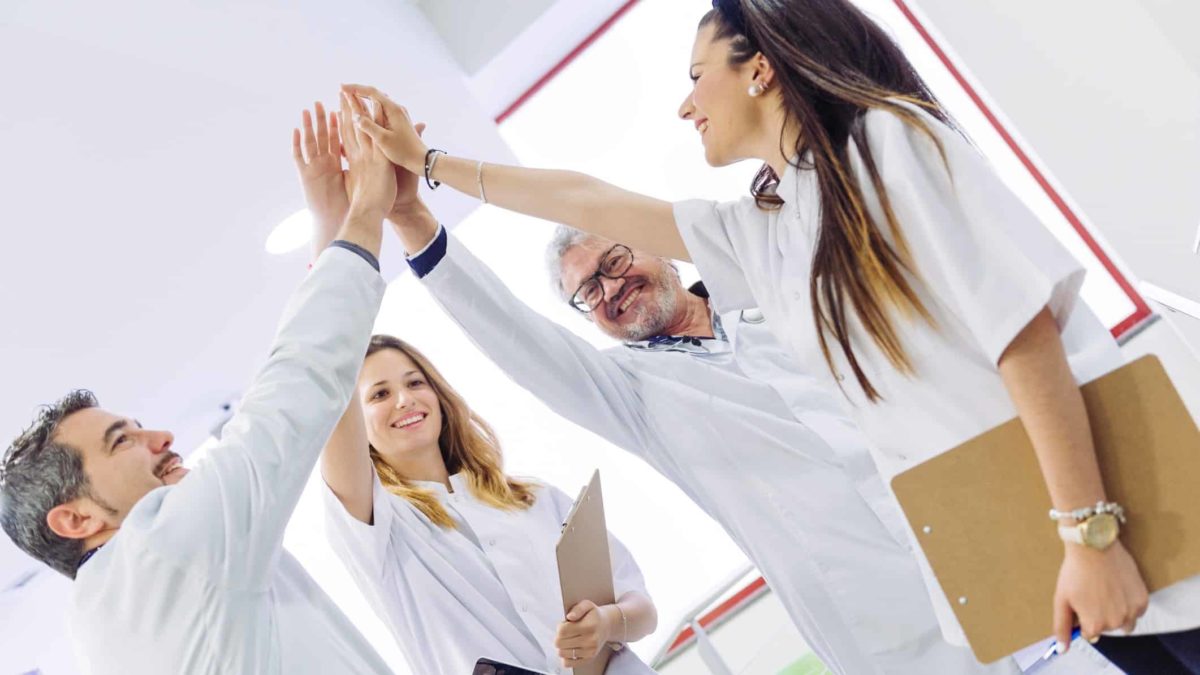 Group of medical professionals high five