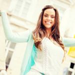 Happy woman holding up shopping bags