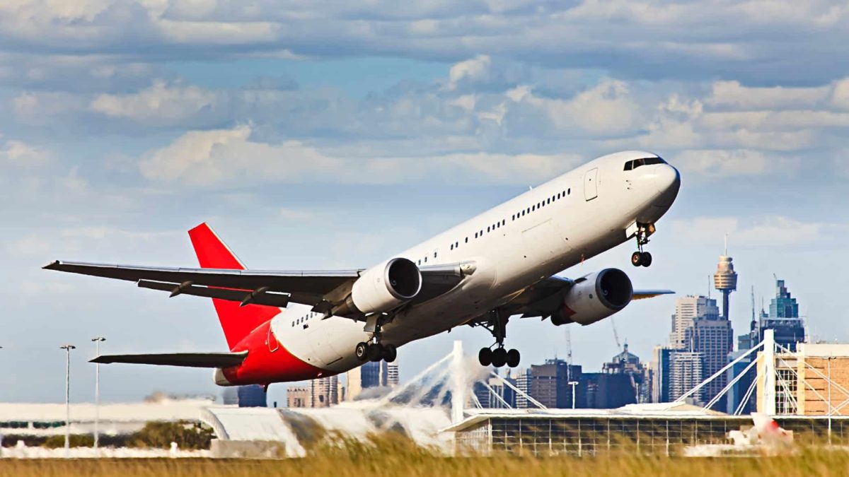 Plane taking off from Sydney airport with CBD in background