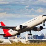Plane taking off from Sydney airport with CBD in background.