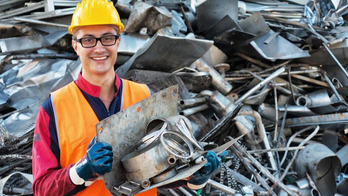 Smiling Worker in Metal Landfill