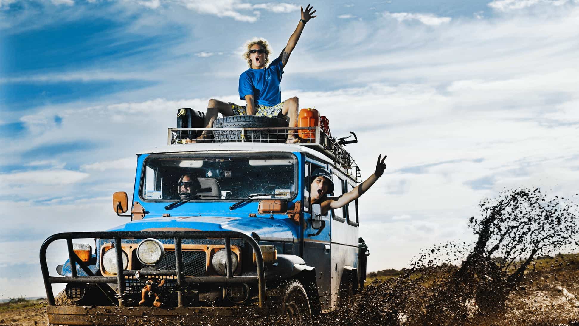 Two men cheer in four wheel drive