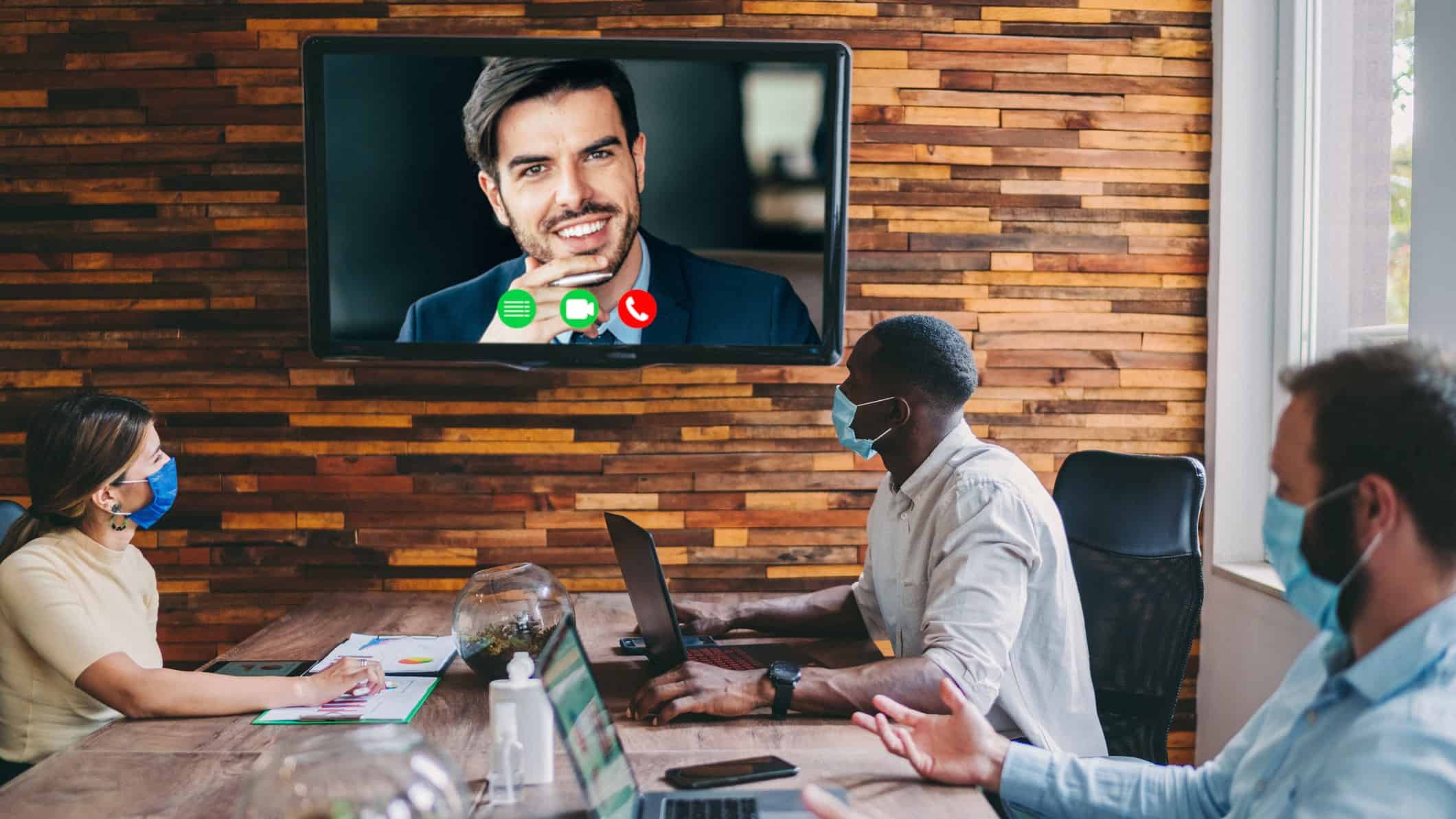 group of people in an office having a virtual meeting