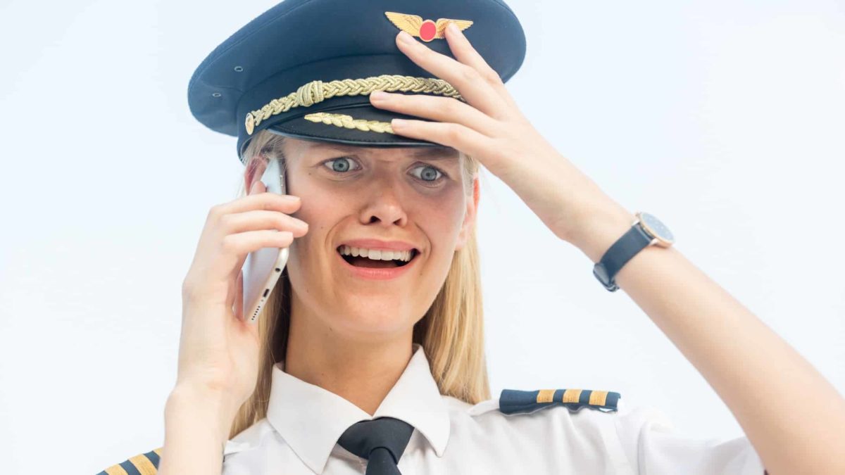 airline pilot on the phone looking distraught, qantas share price
