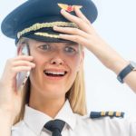 Pilot on the phone looking distraught.