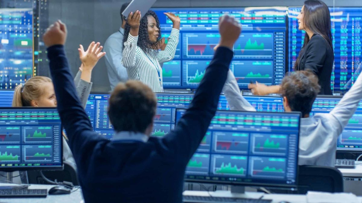 group of traders cheering at stock market