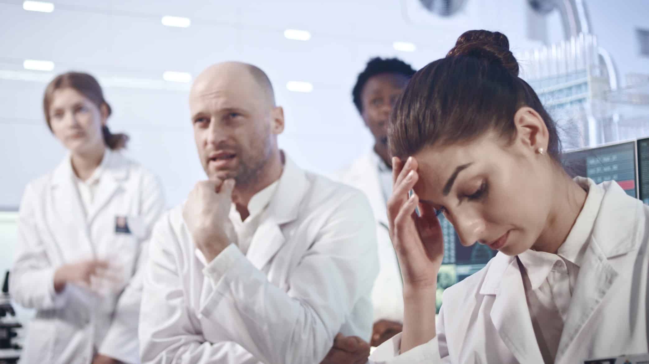 laboratory workers looking disappointed
