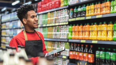 man doing stocktake at supermarket