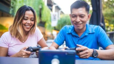 A man and woman playing video games.