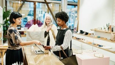 woman in jewellery shop paying through paypal