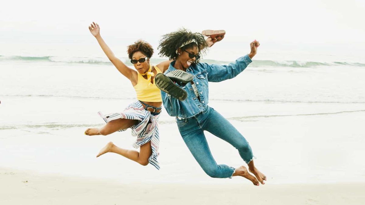 Two women jumping into the air.