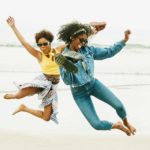 Two women jumping into the air.