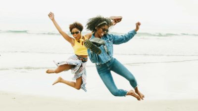 Two women jumping into the air.