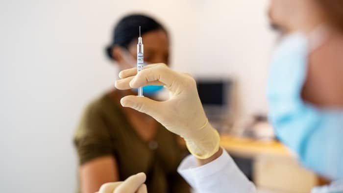 woman preparing Moderna vaccine
