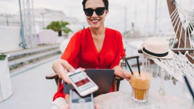 Lady pays for latte with mobile phone tap and pay