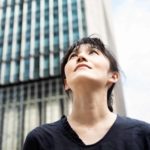 A woman looks towards the sky and the future.