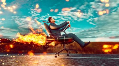 Businessman taking off in rocket-fuelled office chair