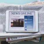 Media newspapers and tablet reporting the news online