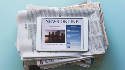 Media newspapers and tablet reporting the news online