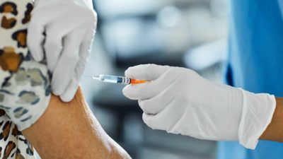 Telstra share price COVID vaccination Injection into arm