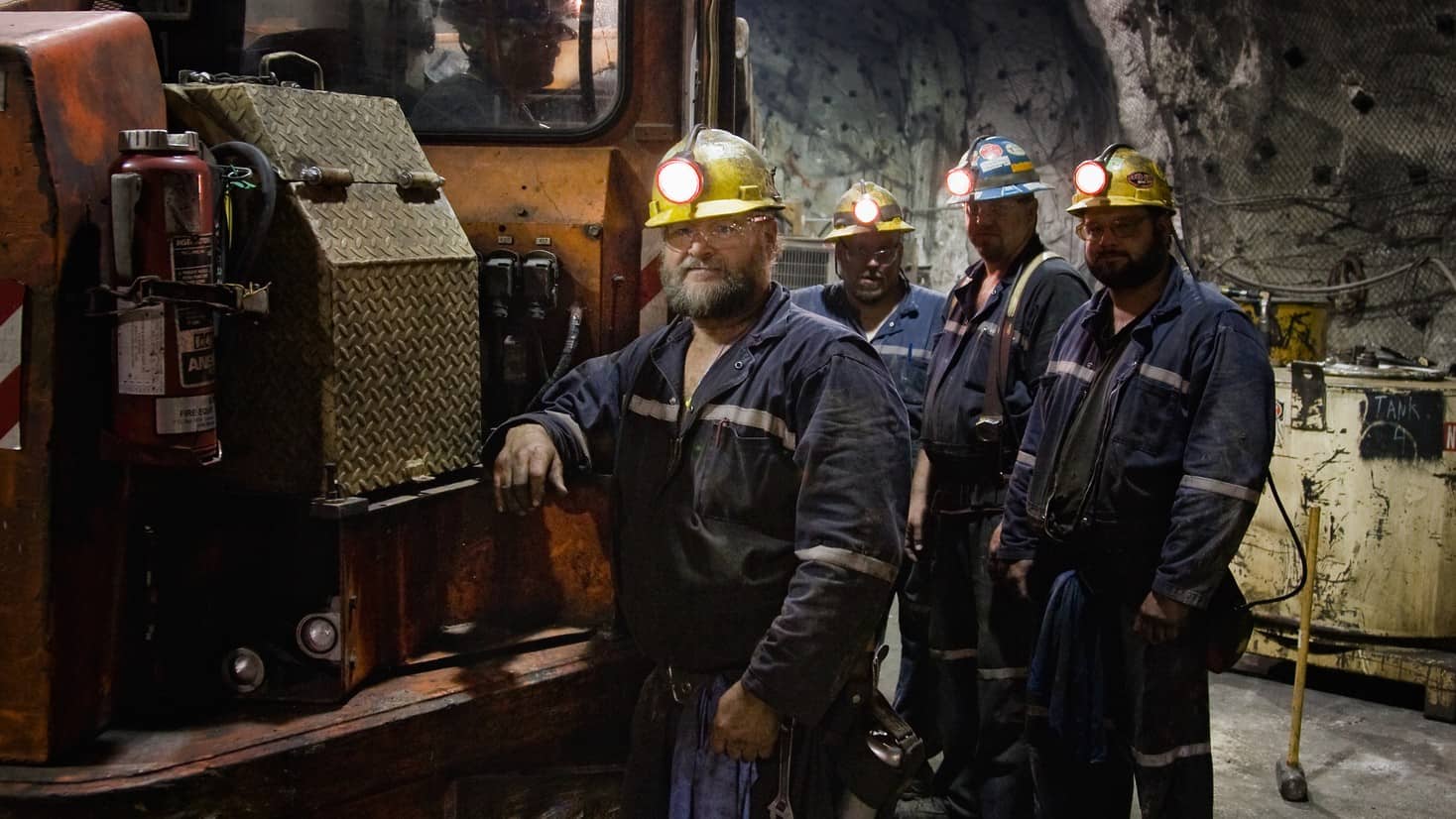 team of miners with machine