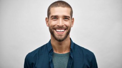 young man smiling in blue shirt