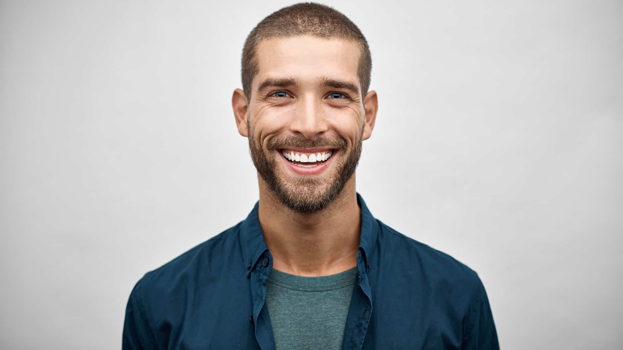young man smiling in blue shirt