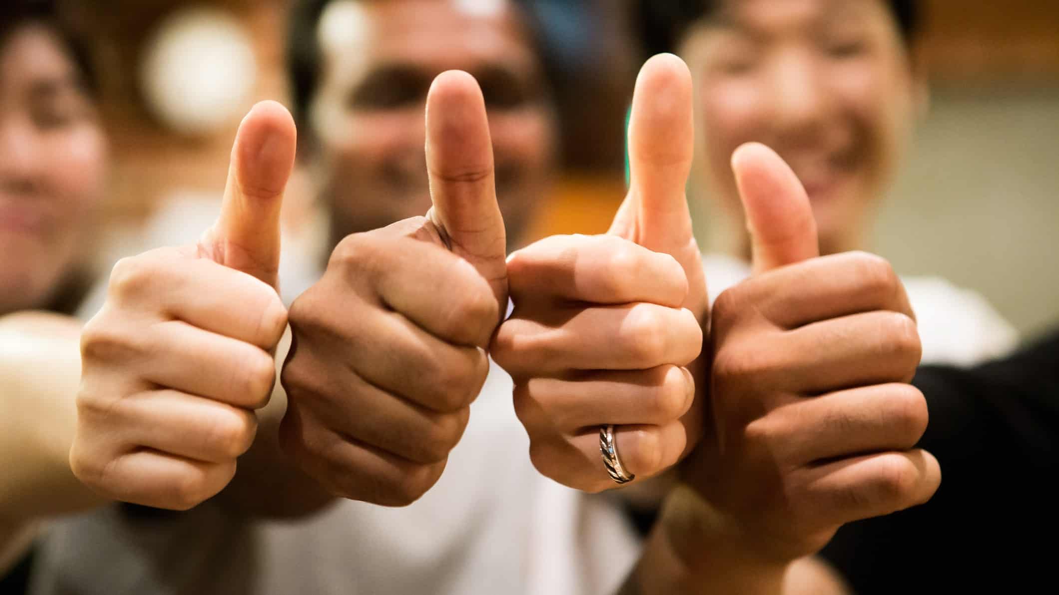 A team of people giving the thumbs up sign after the ACCC approved the Seven West Media acquisition of Prime Media Group