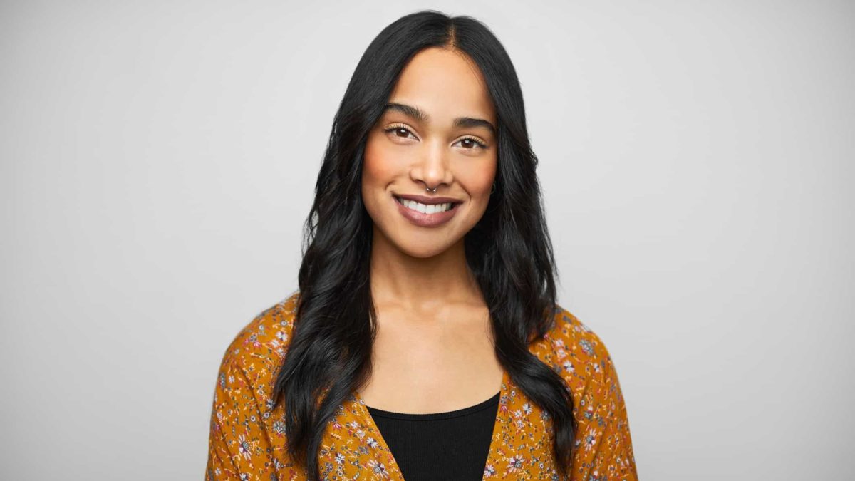 Woman with long hair smiles for the camera.