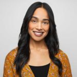 Woman with long hair smiles for the camera.