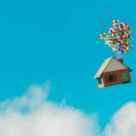 House floats up and away while tied to balloons.