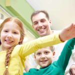 Family of four celebrating inside a grocery store or supermarket