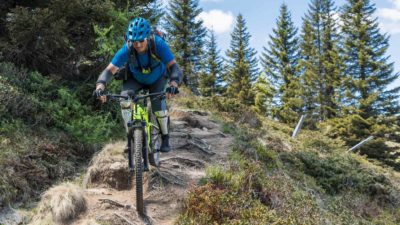 A mountain bike rider navigates down a bumpy track, indicating uncertain economic times ahead