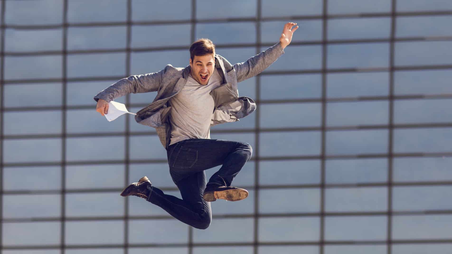 Businessman outside jumps in the air as the Woodside share price rises today