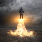 businessman takes off with rockets under feet