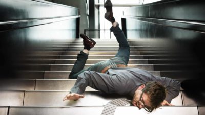 Man in shirt and tie falls face first down stairs representing falling ASX 200 bank shares today