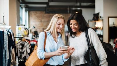 2 women looking at phone