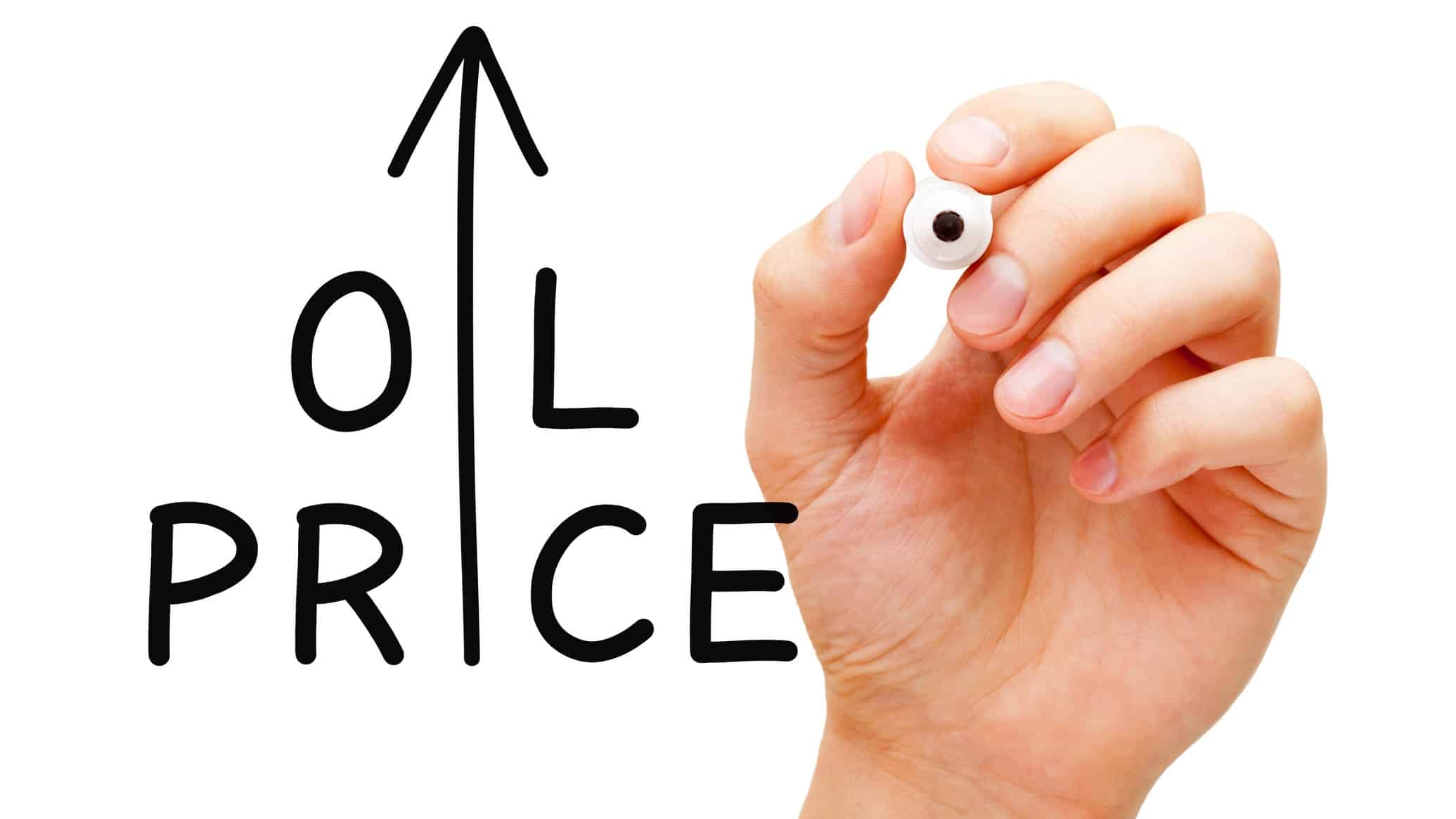 a hand holding a marker pen sits alongside a hand written sign that says OIL PRICE with an upward arrow taking the place of the I in both the words OIL and PRICE.