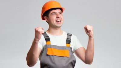 Man in orange hard hat cheers