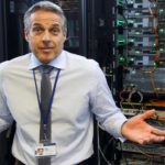 Male IT engineer shrugs his shoulders as he tries to understand network.