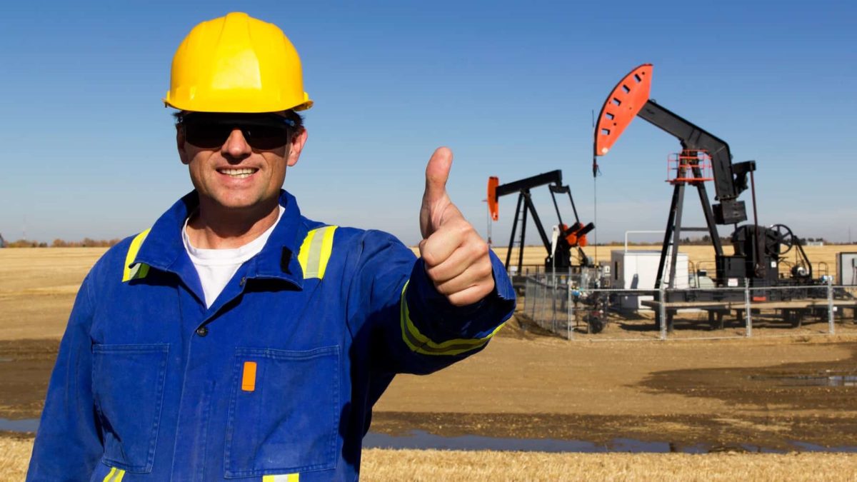 An oil miner with his thumbs up.