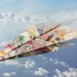 Paper plane made of money in different currencies flies through the sky.