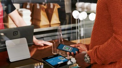 Woman paying using Square.